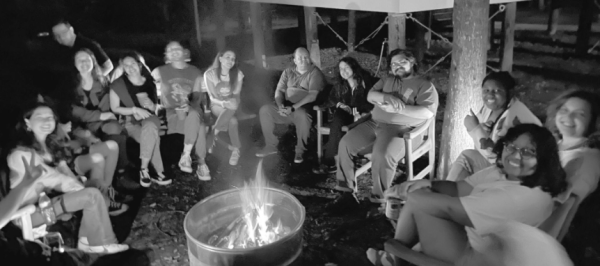 The Maroon staff gathers around a campfire  on retreat, an organizational tradition, on March 22, 2024.